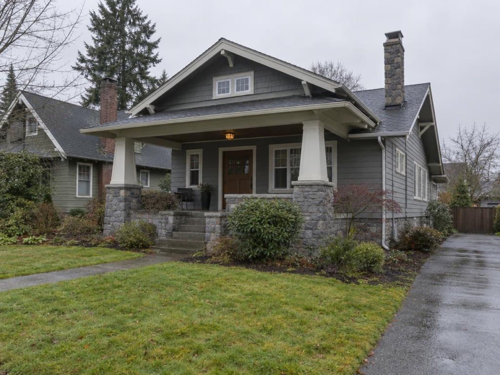 Craftsman bungalow photographed on a phone under a flat grey overcast sky